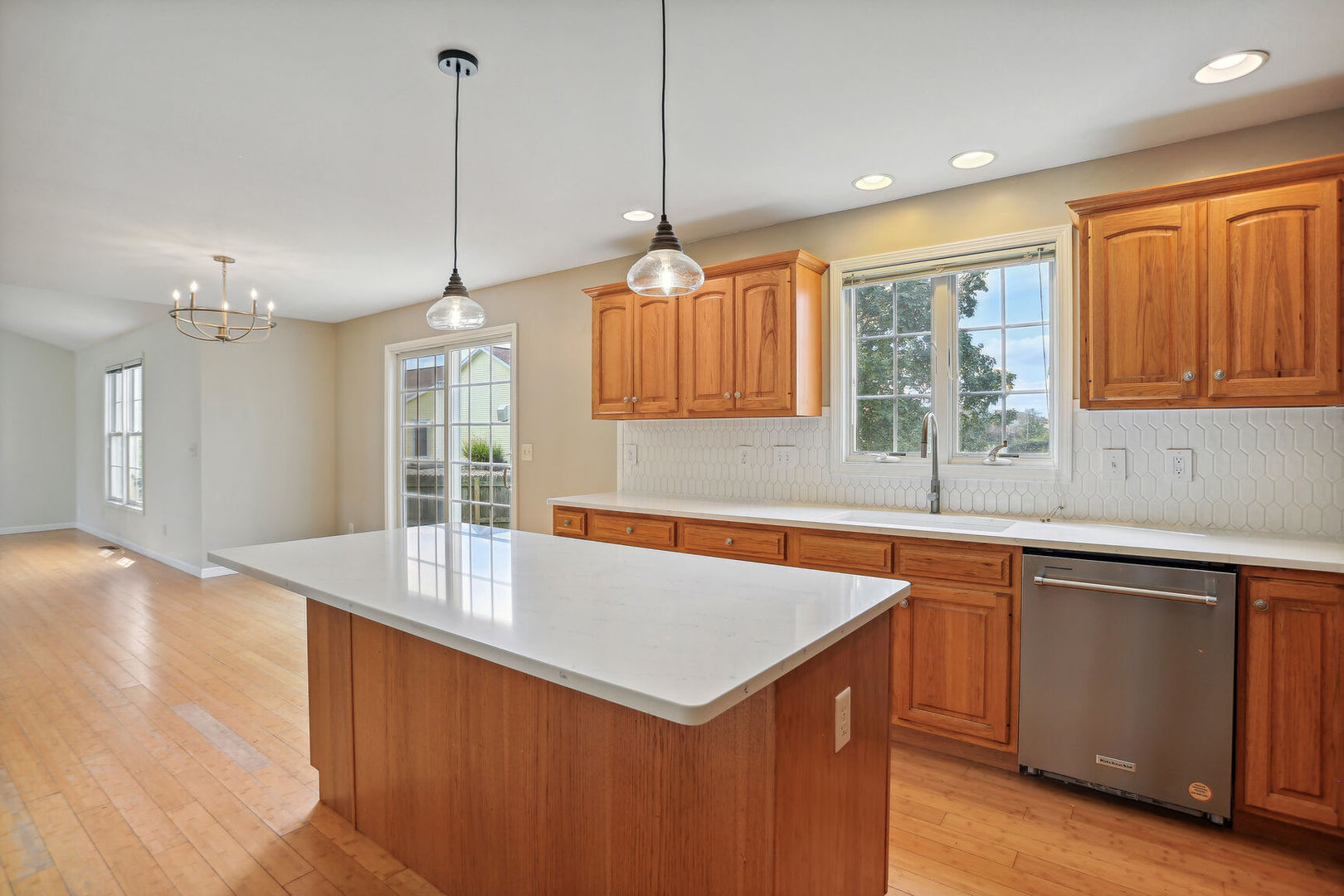 905 Switchgrass Lane Champaign, IL 61822 - Photo 18 of 51 a kitchen with a sink a center island and wooden floor