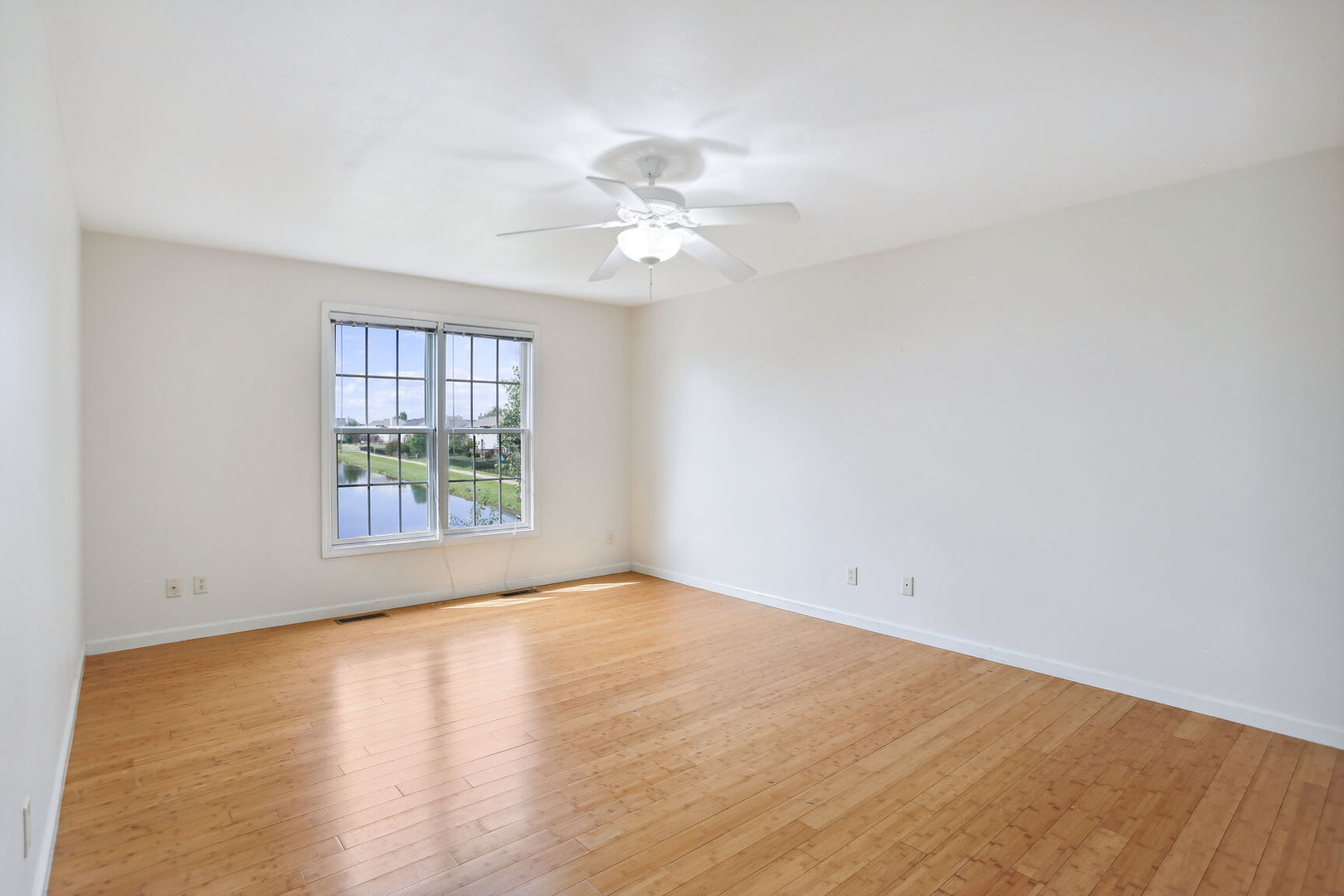 905 Switchgrass Lane Champaign, IL 61822 - Photo 22 of 51 wooden floor in an empty room with a window