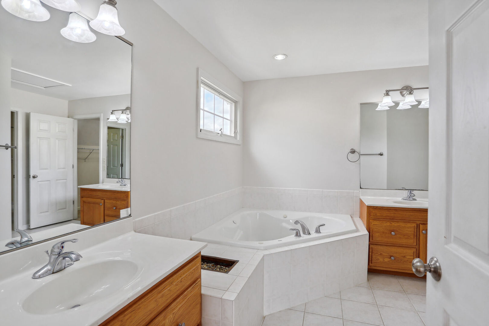 905 Switchgrass Lane Champaign, IL 61822 - Photo 24 of 51 a bathroom with a tub sink and mirror