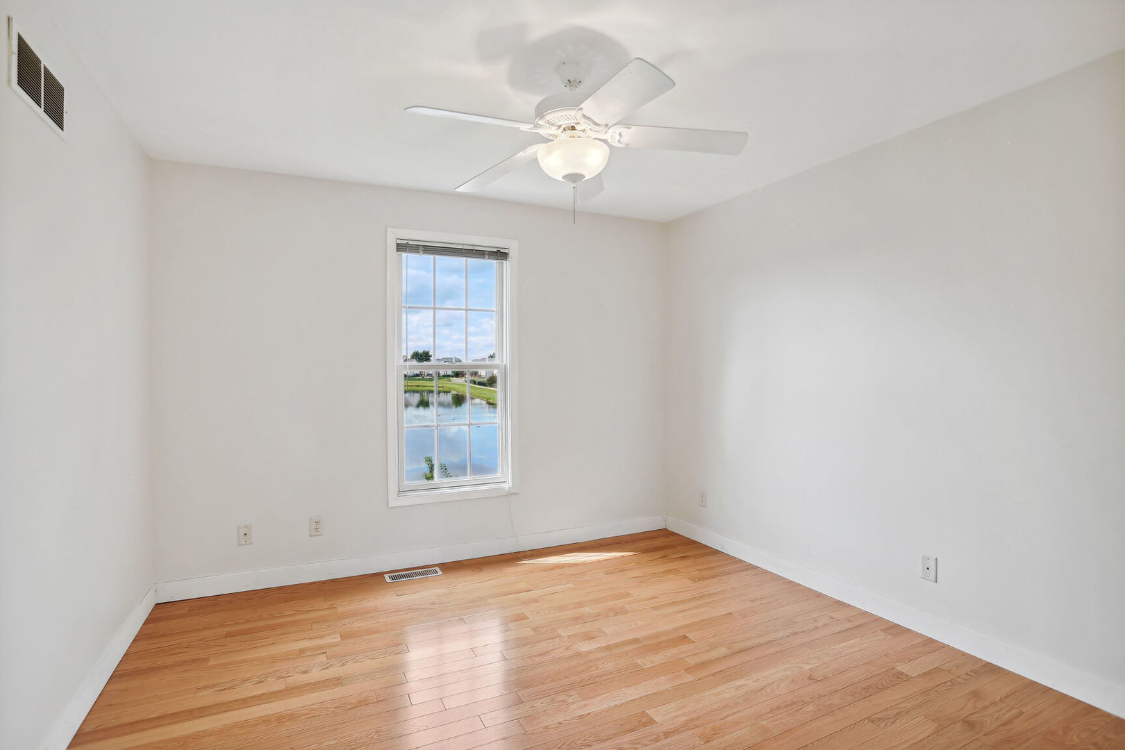 905 Switchgrass Lane Champaign, IL 61822 - Photo 27 of 51 a view of an empty room with wooden floor and a window
