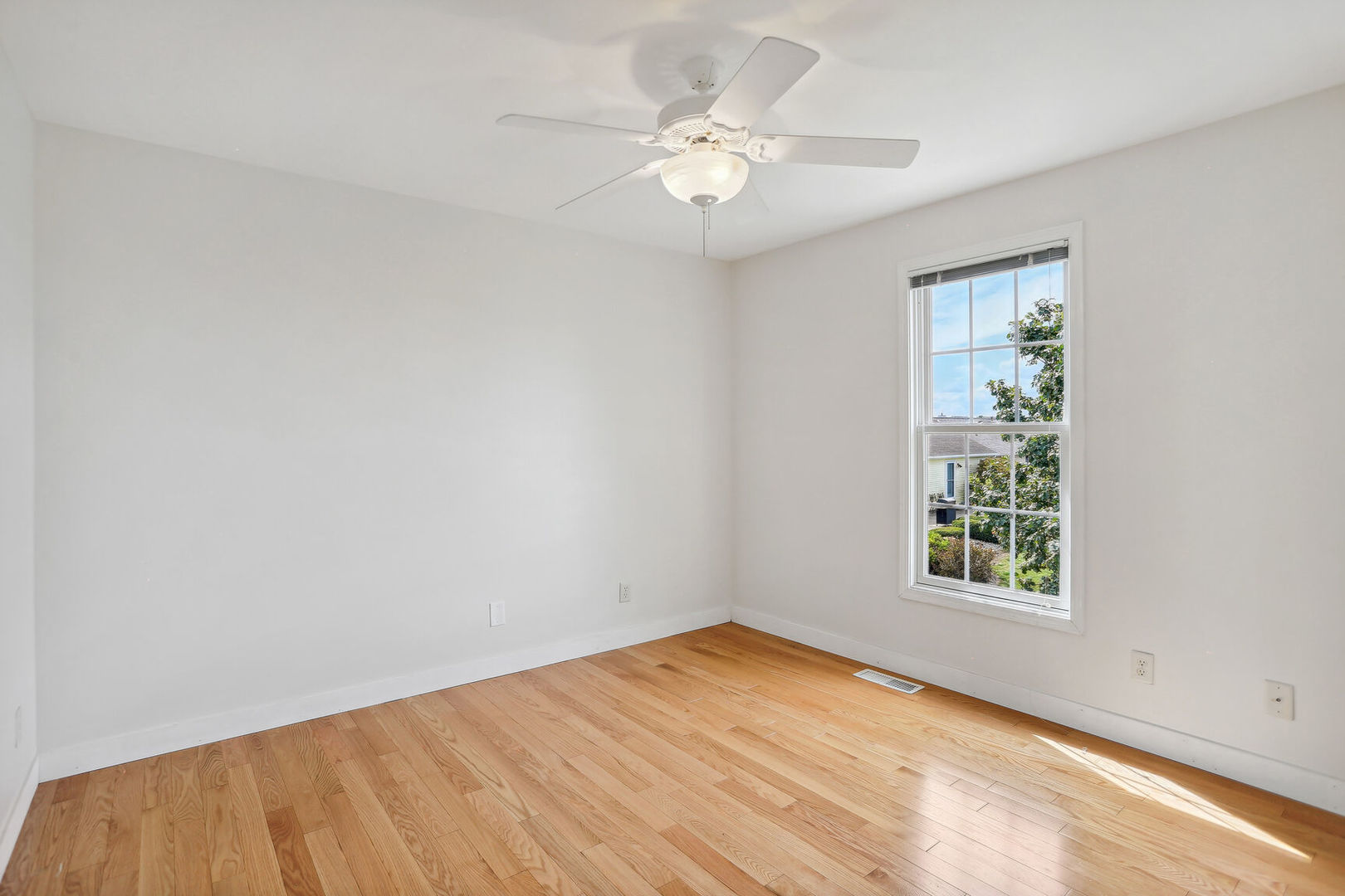 905 Switchgrass Lane Champaign, IL 61822 - Photo 29 of 51 wooden floor in an empty room with a window