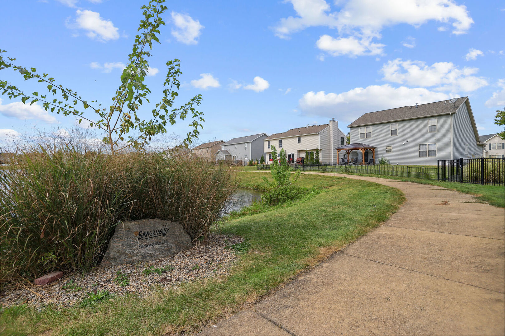 905 Switchgrass Lane Champaign, IL 61822 - Photo 46 of 51 a view of a big house with a big yard and potted plants