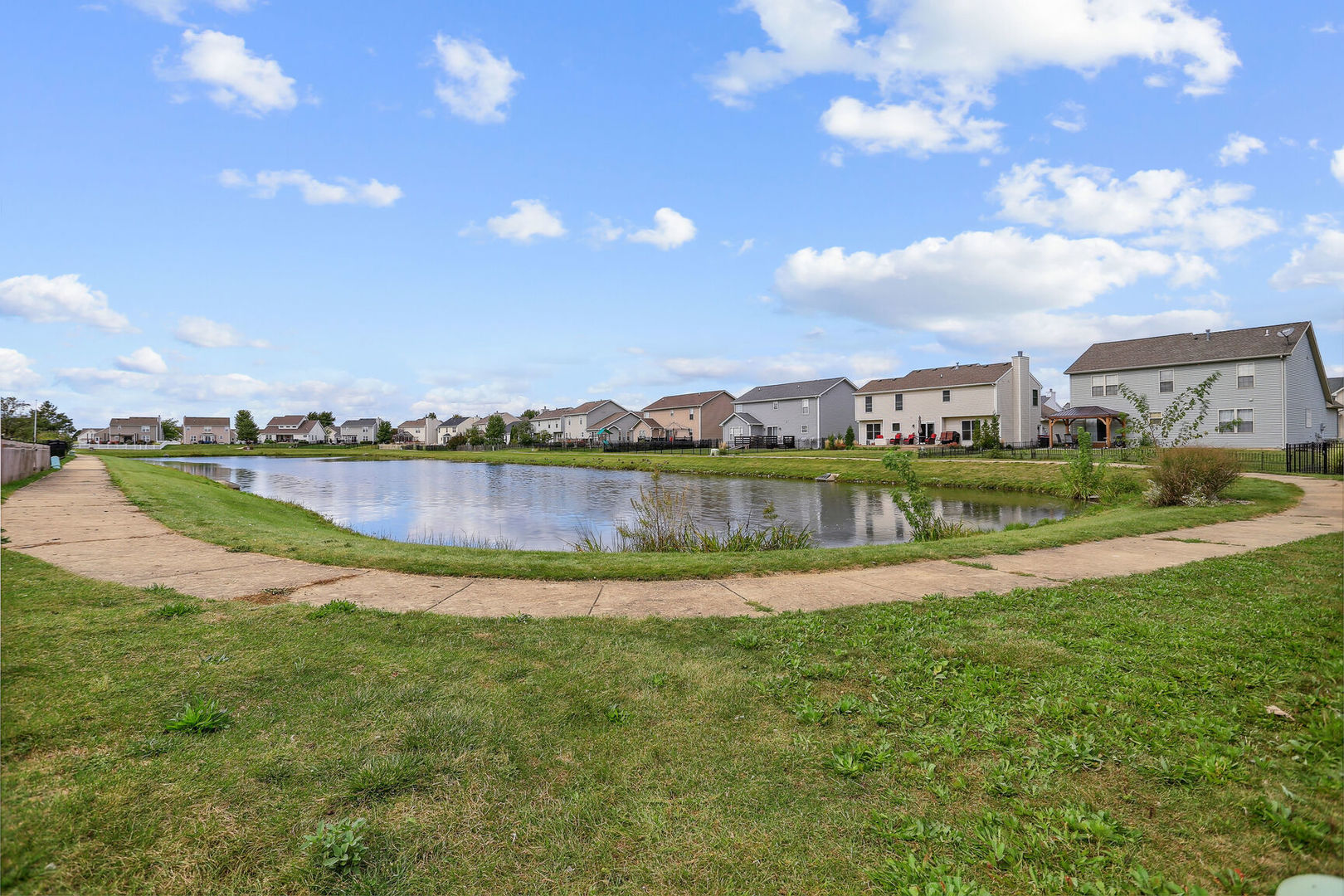 905 Switchgrass Lane Champaign, IL 61822 - Photo 47 of 51 a view of a lake with houses in the back