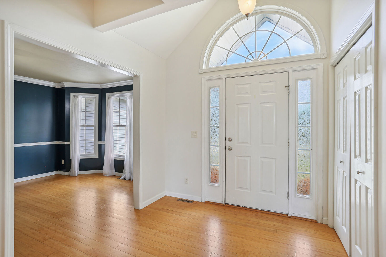 905 Switchgrass Lane Champaign, IL 61822 - Photo 6 of 51 an empty room with wooden floor cabinet and a ceiling fan
