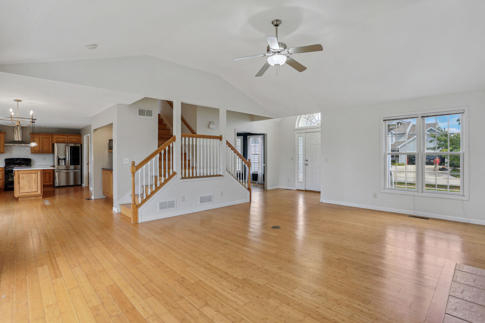 905 Switchgrass Lane Champaign, IL 61822 - Photo 9 of 51 a view of a livingroom with wooden floor and a ceiling fan