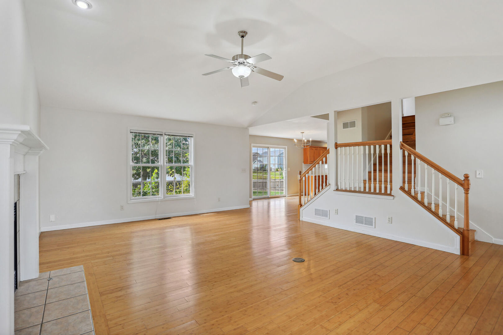 905 Switchgrass Lane Champaign, IL 61822 - Photo 10 of 51 a view of an empty room with wooden floor and a window