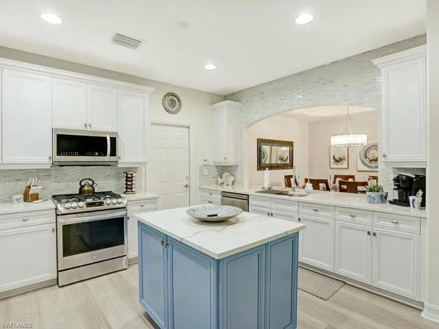 a kitchen with a sink stove and microwave