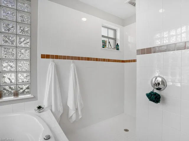 a bathroom with a tub and a shower