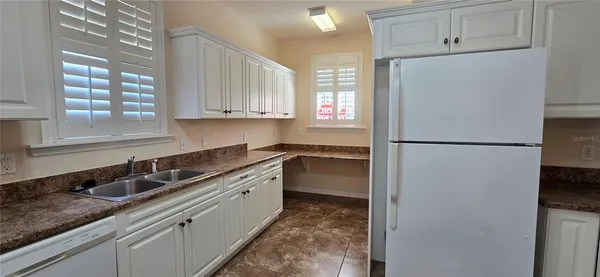 a kitchen with a refrigerator and a sink