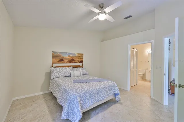 a bedroom with a bed and a ceiling fan