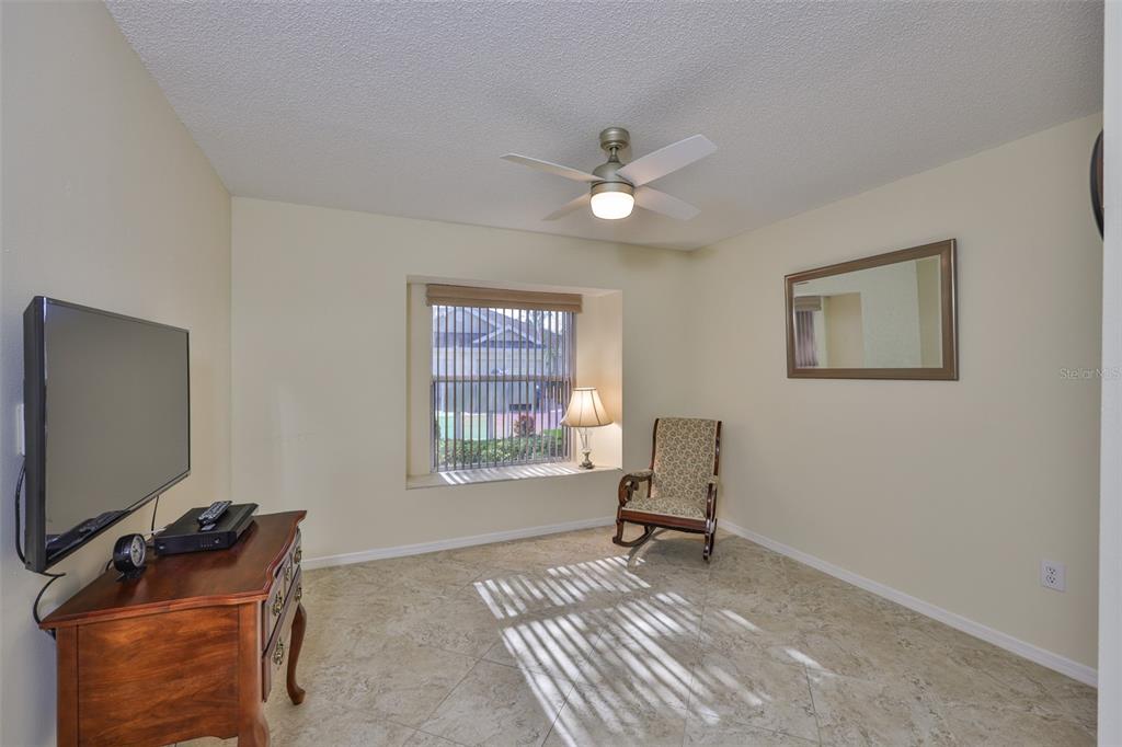 2431 Nantucket Harbor Loop, Unit 61 Sun City Center, FL 33573 - Photo 19 of 37 a living room with furniture and a window