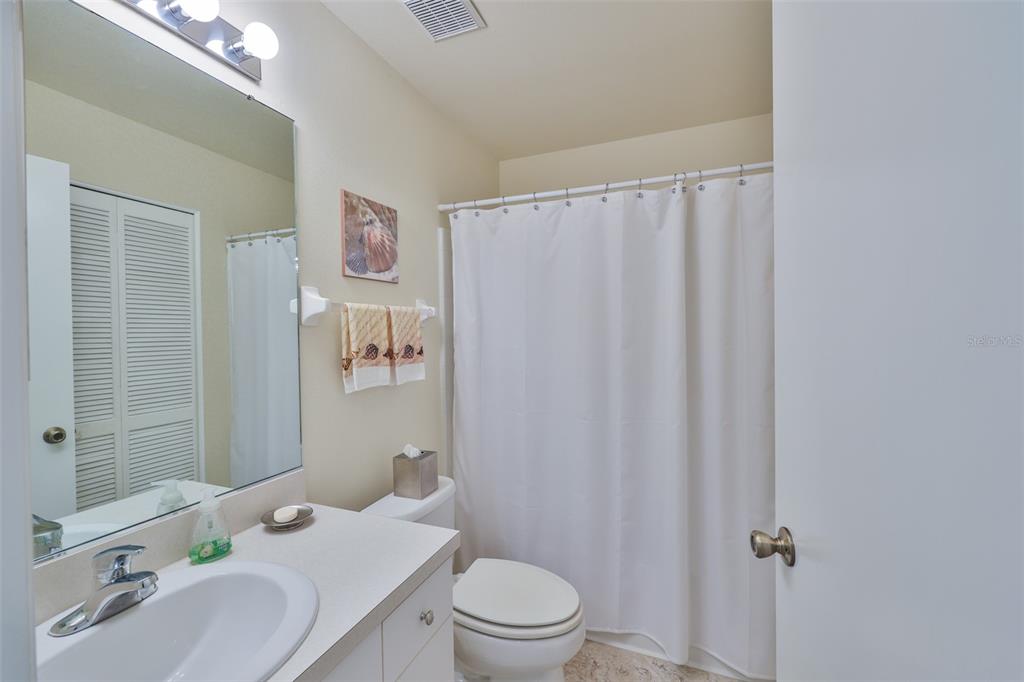 2431 Nantucket Harbor Loop, Unit 61 Sun City Center, FL 33573 - Photo 22 of 37 a bathroom with a sink a toilet and shower curtain