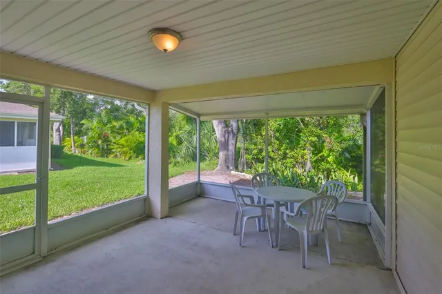a view of a porch with chairs and backyard