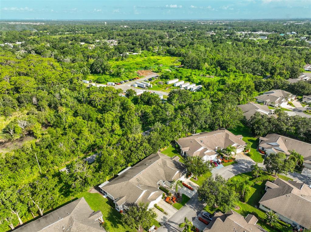 2431 Nantucket Harbor Loop, Unit 61 Sun City Center, FL 33573 - Photo 31 of 37 an aerial view of a houses with a yard