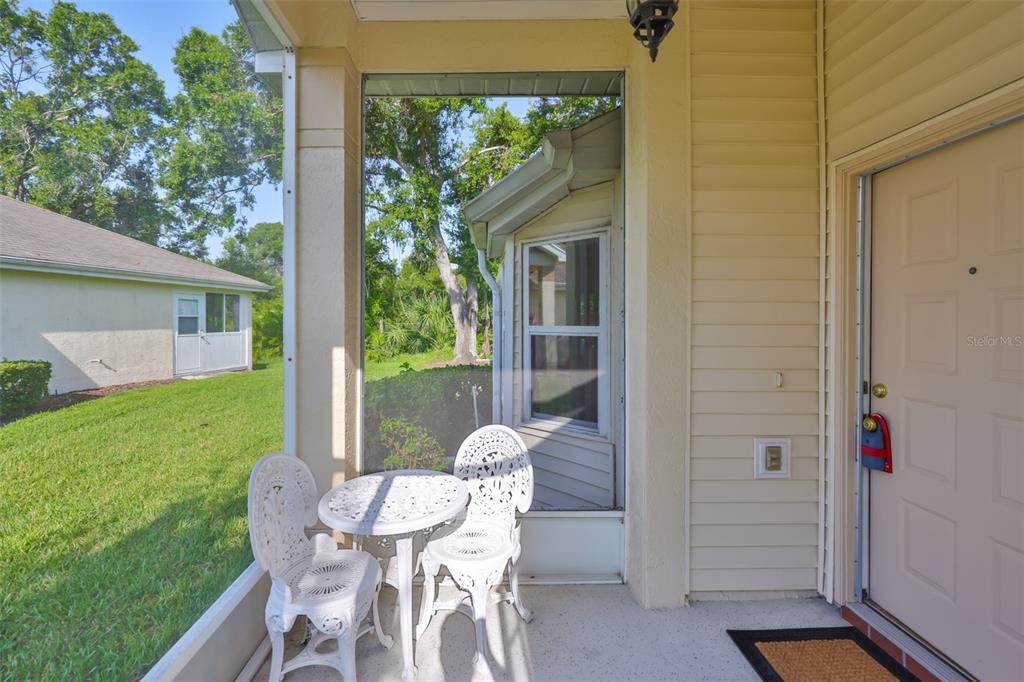 2431 Nantucket Harbor Loop, Unit 61 Sun City Center, FL 33573 - Photo 5 of 37 a view of a porch with chairs and backyard