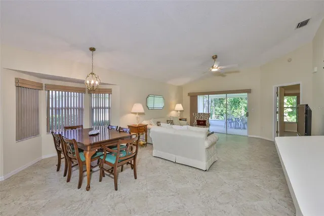 a view of a dining room with furniture and window