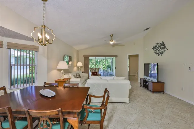 a view of a dining room with furniture wooden floor and chandelier
