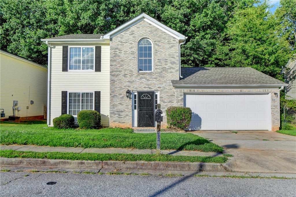 3266 Springside Ridge Decatur, GA 30034 - Photo 1 of 1 a front view of a house with a yard and garage