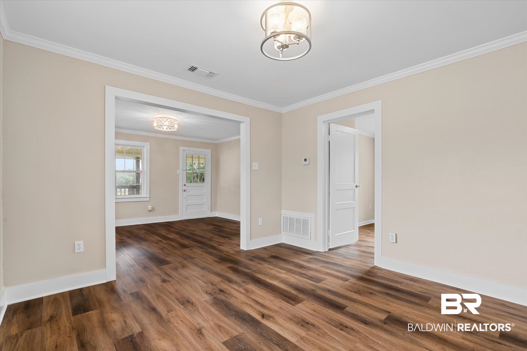 4630 General Road Mobile, AL 36619 - Photo 9 of 33 Unfurnished room with crown molding, a chandelier, and dark hardwood / wood-style floors