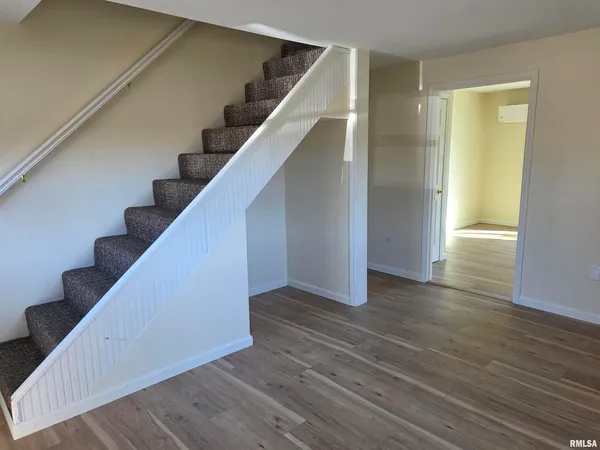 wooden floor in an empty room with wooden floor and entryway