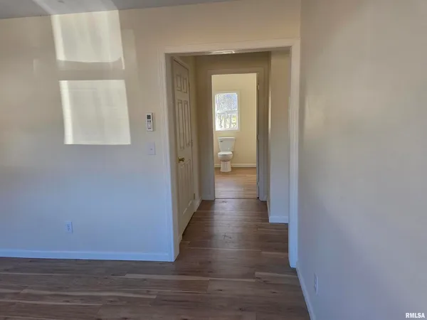 a view of a hallway with wooden floor