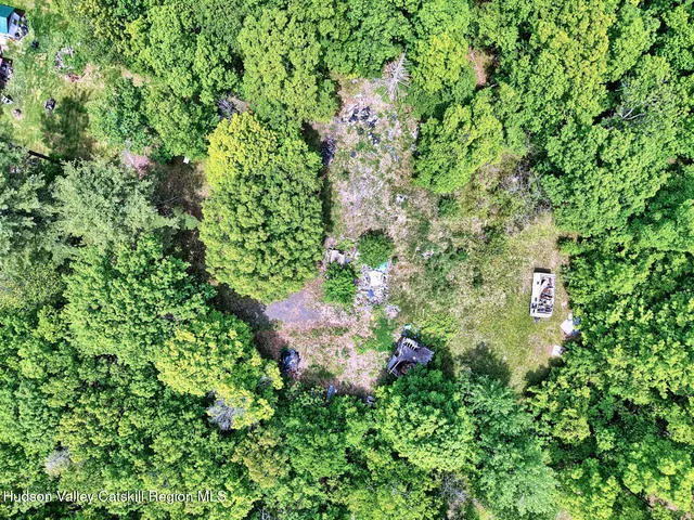 a backyard of a house with a tree