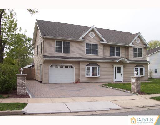 4 Altamont Road Edison, NJ 08817 - Photo 1 of 9 a front view of a house with a yard and garage