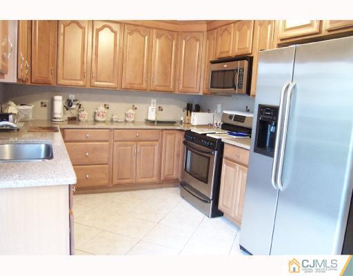 4 Altamont Road Edison, NJ 08817 - Photo 5 of 9 a kitchen with stainless steel appliances granite countertop a refrigerator sink and stove