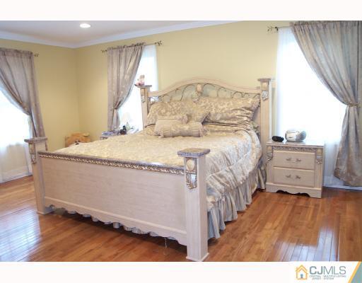 4 Altamont Road Edison, NJ 08817 - Photo 6 of 9 a bedroom with a bed window and a flat tv screen on dresser