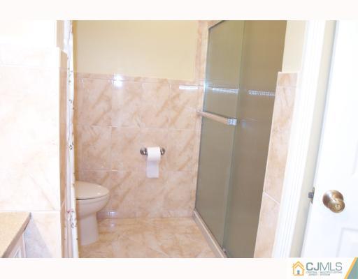 4 Altamont Road Edison, NJ 08817 - Photo 7 of 9 a bathroom with a granite countertop shower and a toilet