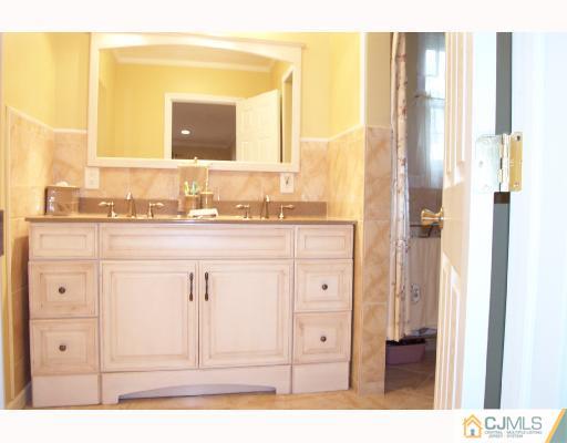 4 Altamont Road Edison, NJ 08817 - Photo 8 of 9 a bathroom with a granite countertop sink and a mirror
