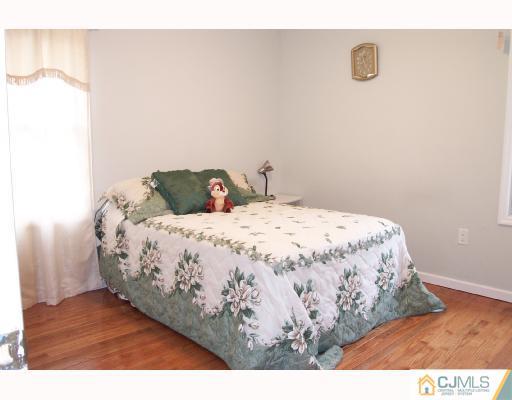 4 Altamont Road Edison, NJ 08817 - Photo 9 of 9 a bedroom with a bed and wooden floor