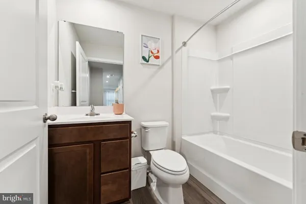 a bathroom with a sink toilet vanity and tub