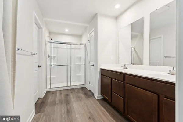 a bathroom with a double vanity sink and mirror