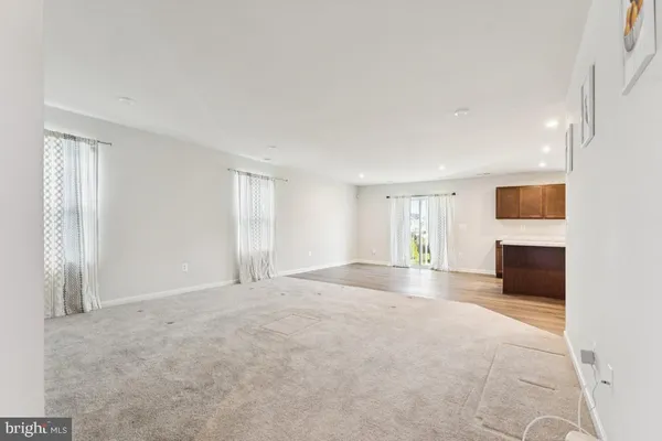 a view of empty room with a fireplace