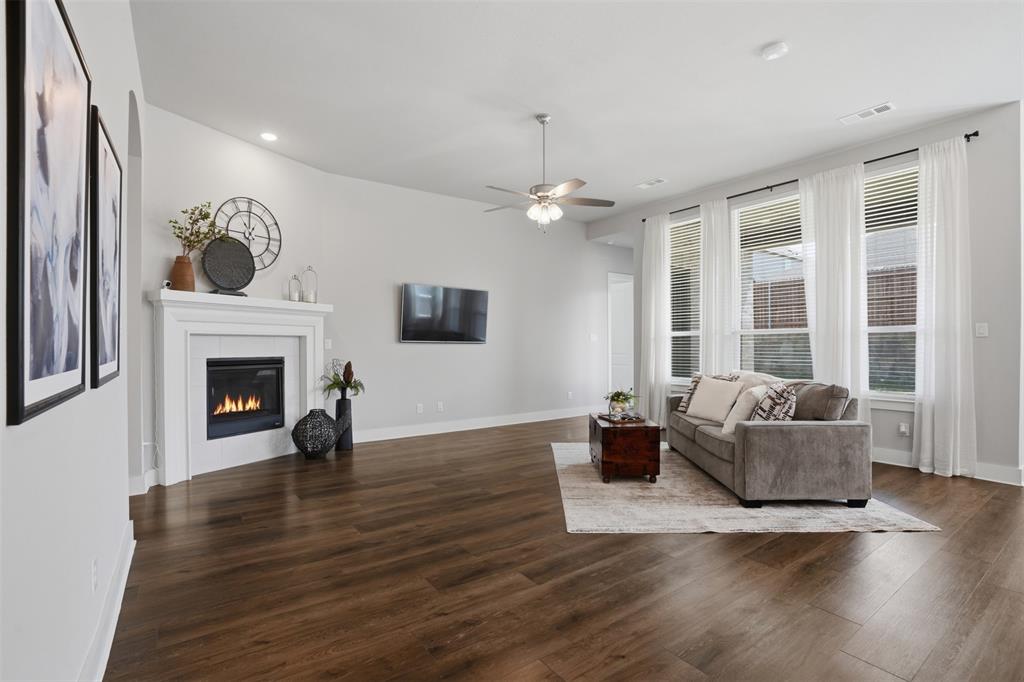 1915 Hillside Court Van Alstyne, TX 75495 - Photo 4 of 36 Large living area with fire place and lots of natural light