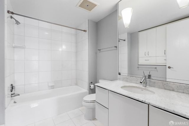 a bedroom with a balcony a bed and a painting on the wall