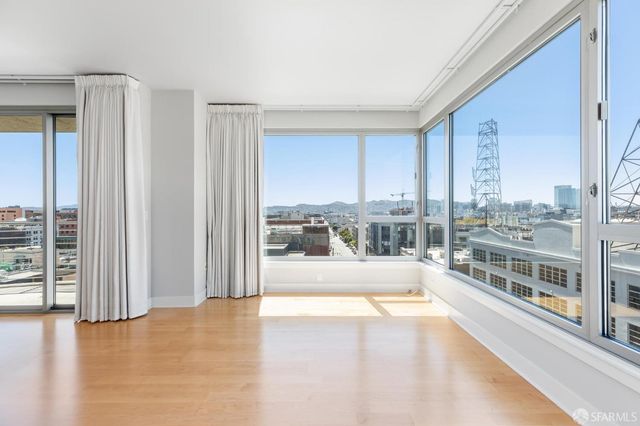 a living room with furniture wooden floor and a table