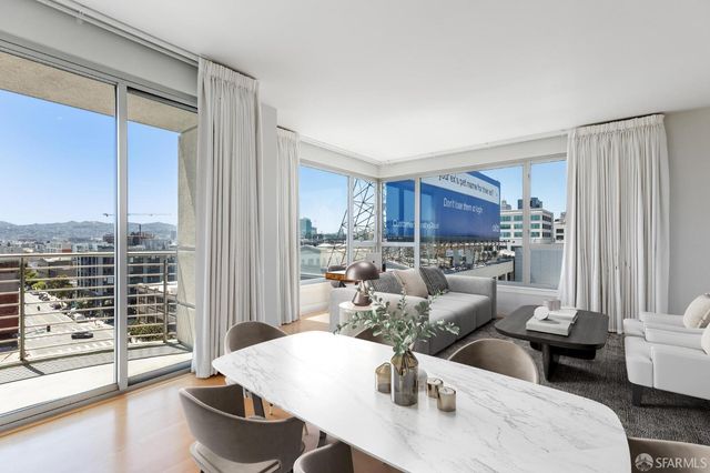 a view of a large kitchen with wooden floor and a window