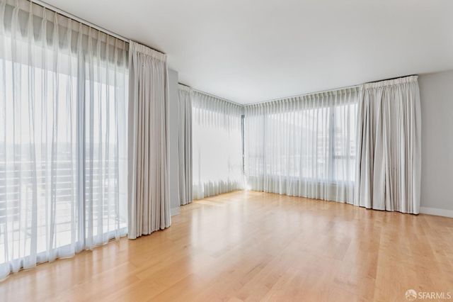 a view of a living room with a floor to ceiling window and glass door