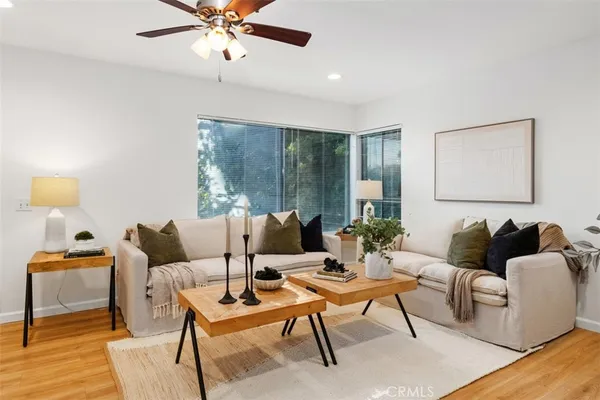 a living room with furniture and a ceiling fan