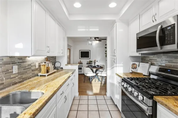 a kitchen with a sink a stove and cabinets