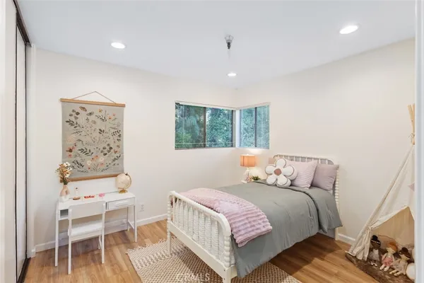 a bedroom with a bed and a chair