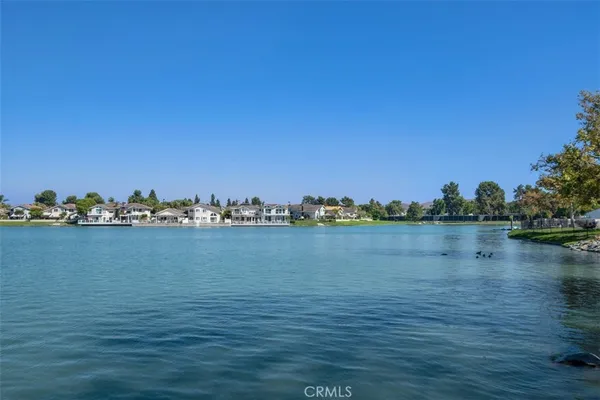 a view of a lake with houses in the back