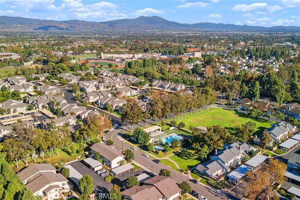 an aerial view of residential houses with outdoor space
