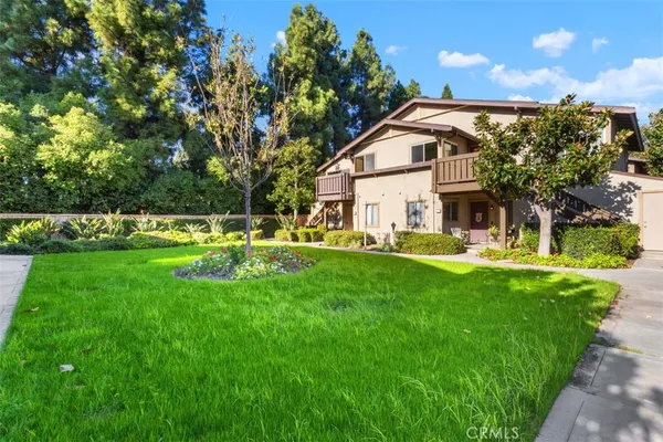 a view of backyard with swimming pool and green space