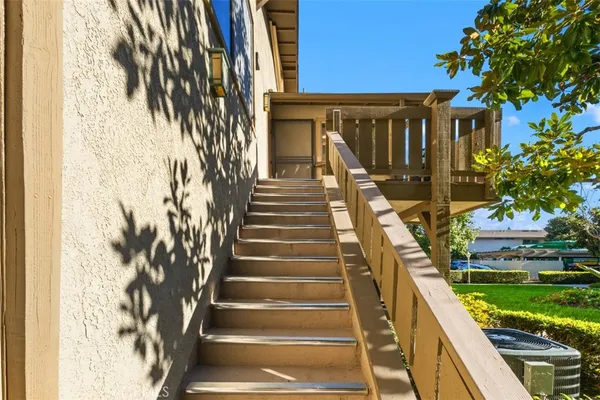 a view of staircase with wooden floor and a potted plant