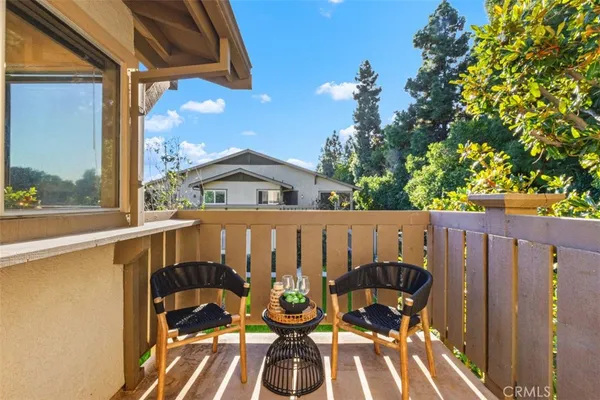 a view of a chairs and table in the balcony