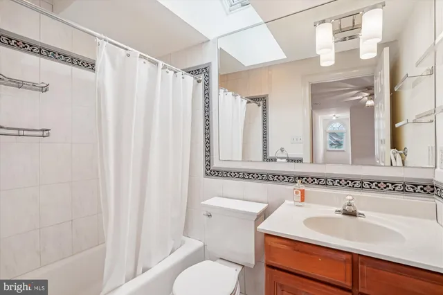 a bathroom with a sink toilet a mirror and shower