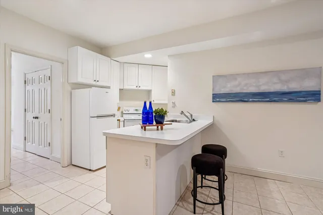 a kitchen with a sink cabinets and appliances